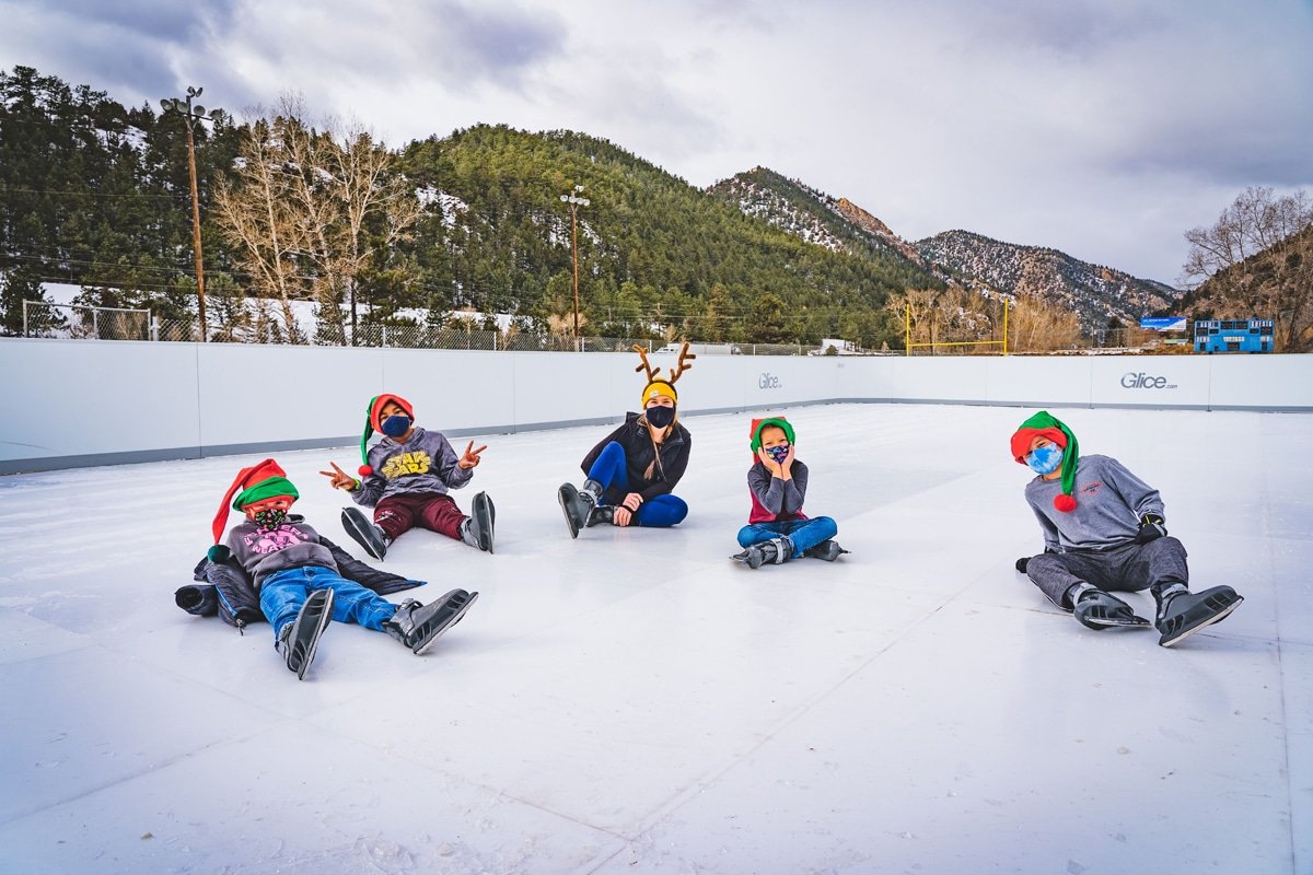 Kids sitting on the ice at Frozen Fire Ice Rink Idaho Springs